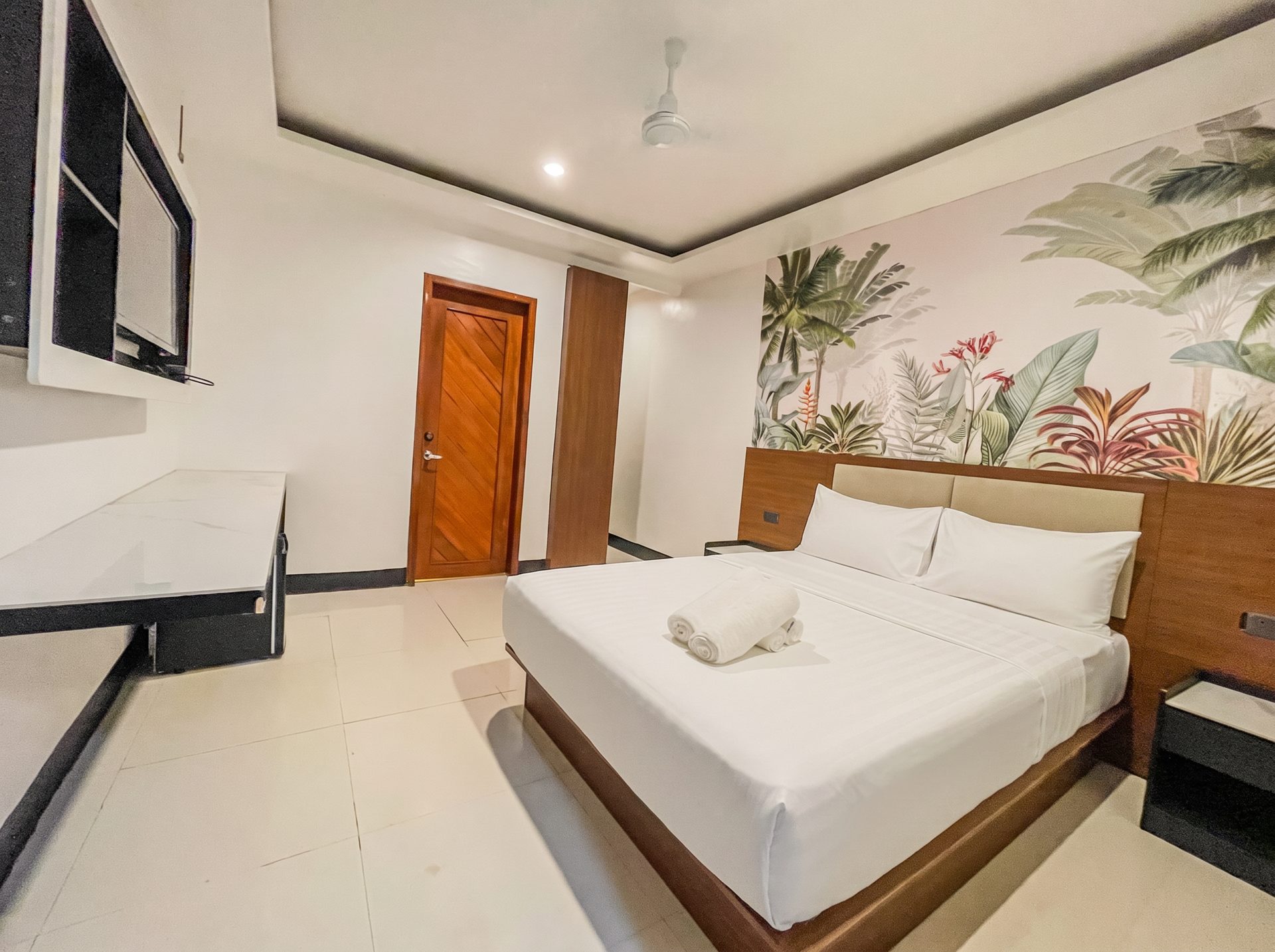 King bed with tropical mural and marble desk at The Town