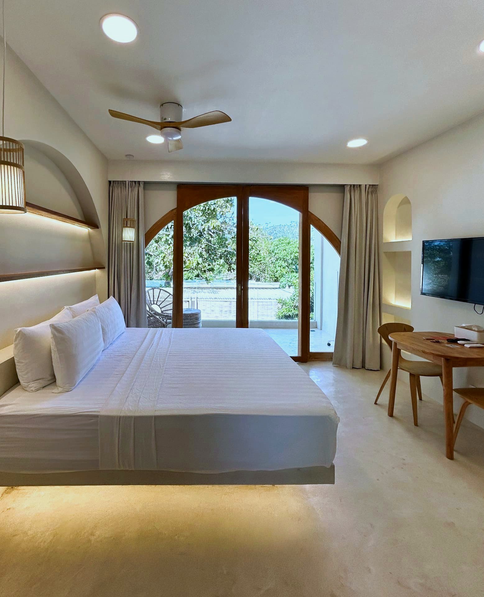 King studio with arched doors opening to a private balcony at Namal Resort