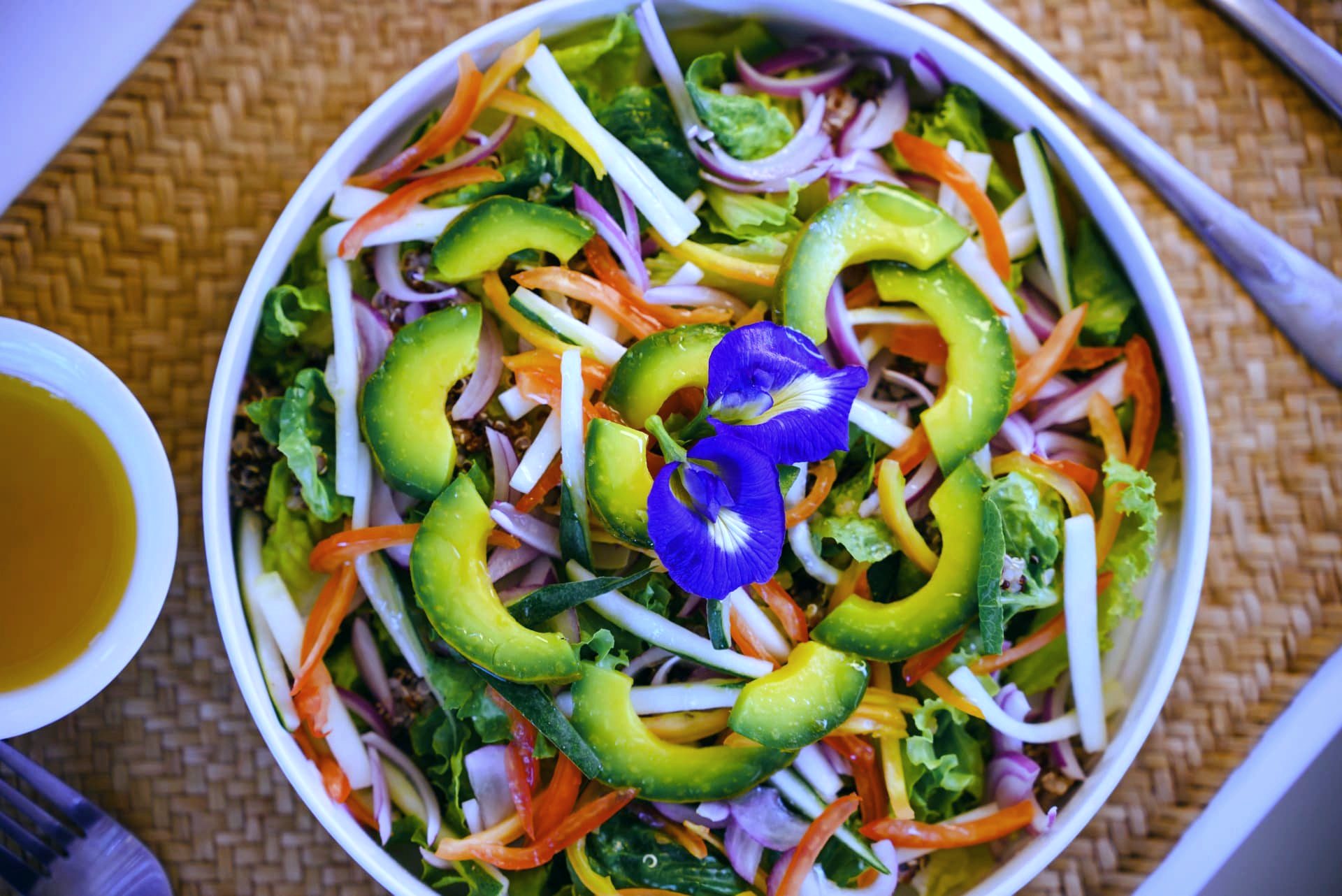 Avocado and quinoa garden salad with edible flowers