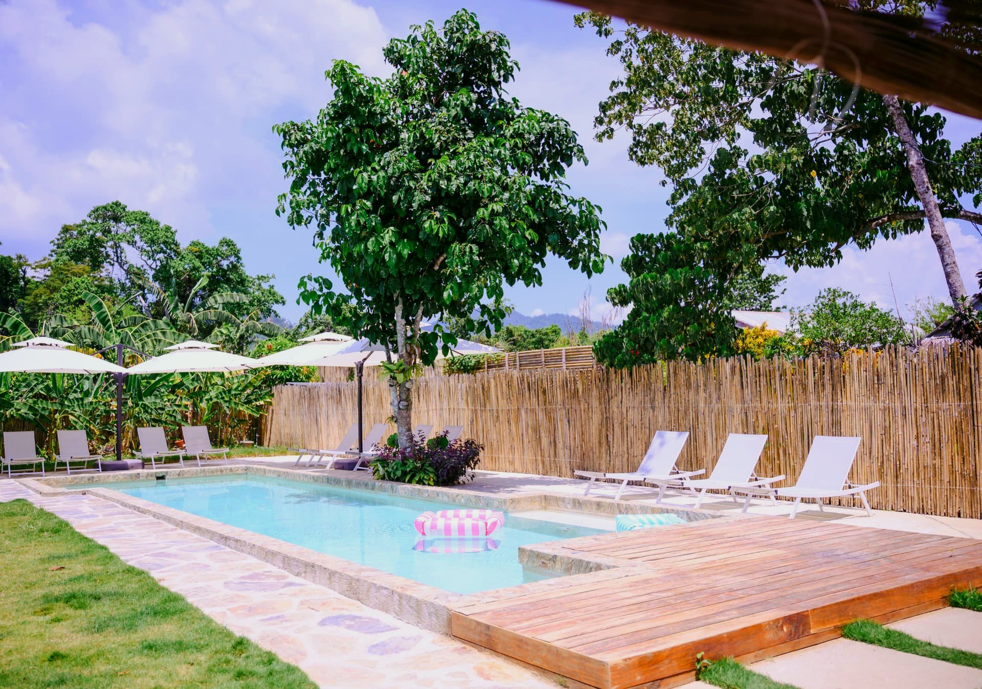 Pool with wooden deck and tropical garden at Namal Resort