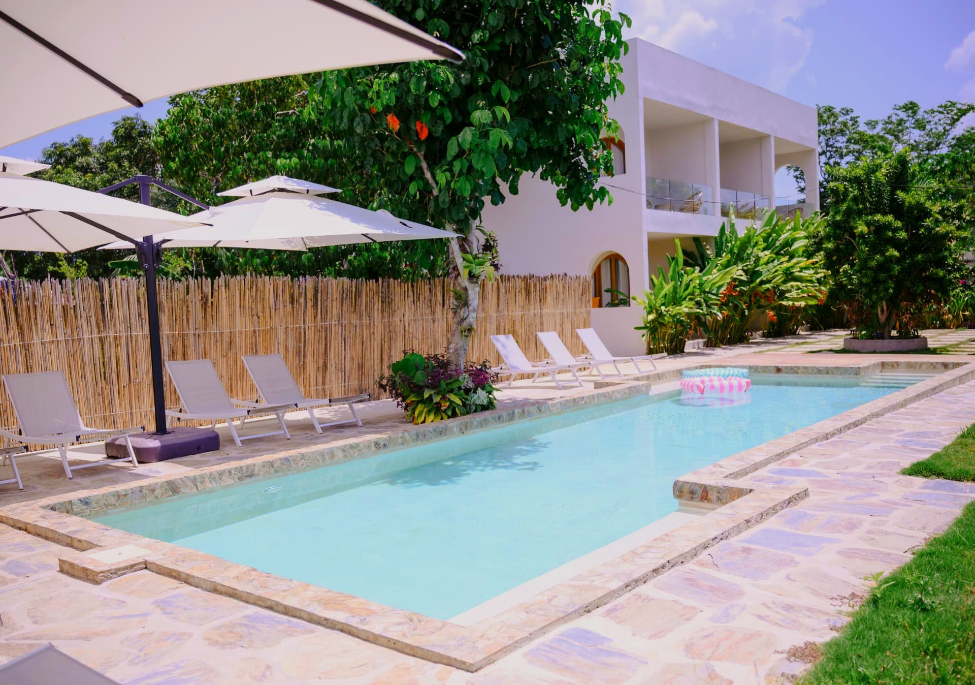 Swimming pool with sun loungers and parasols at Namal Resort