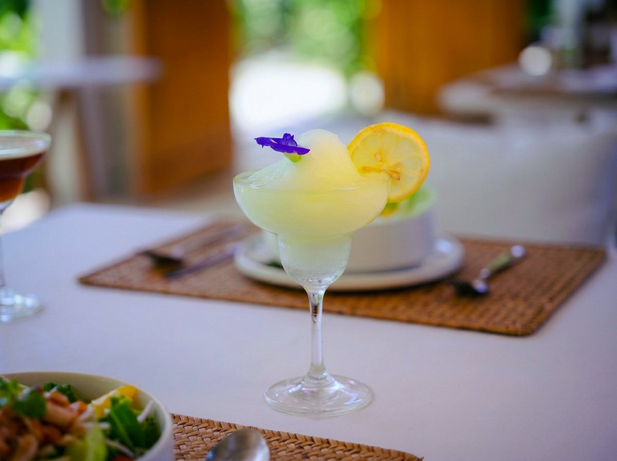 Frozen lemon margarita with an edible flower