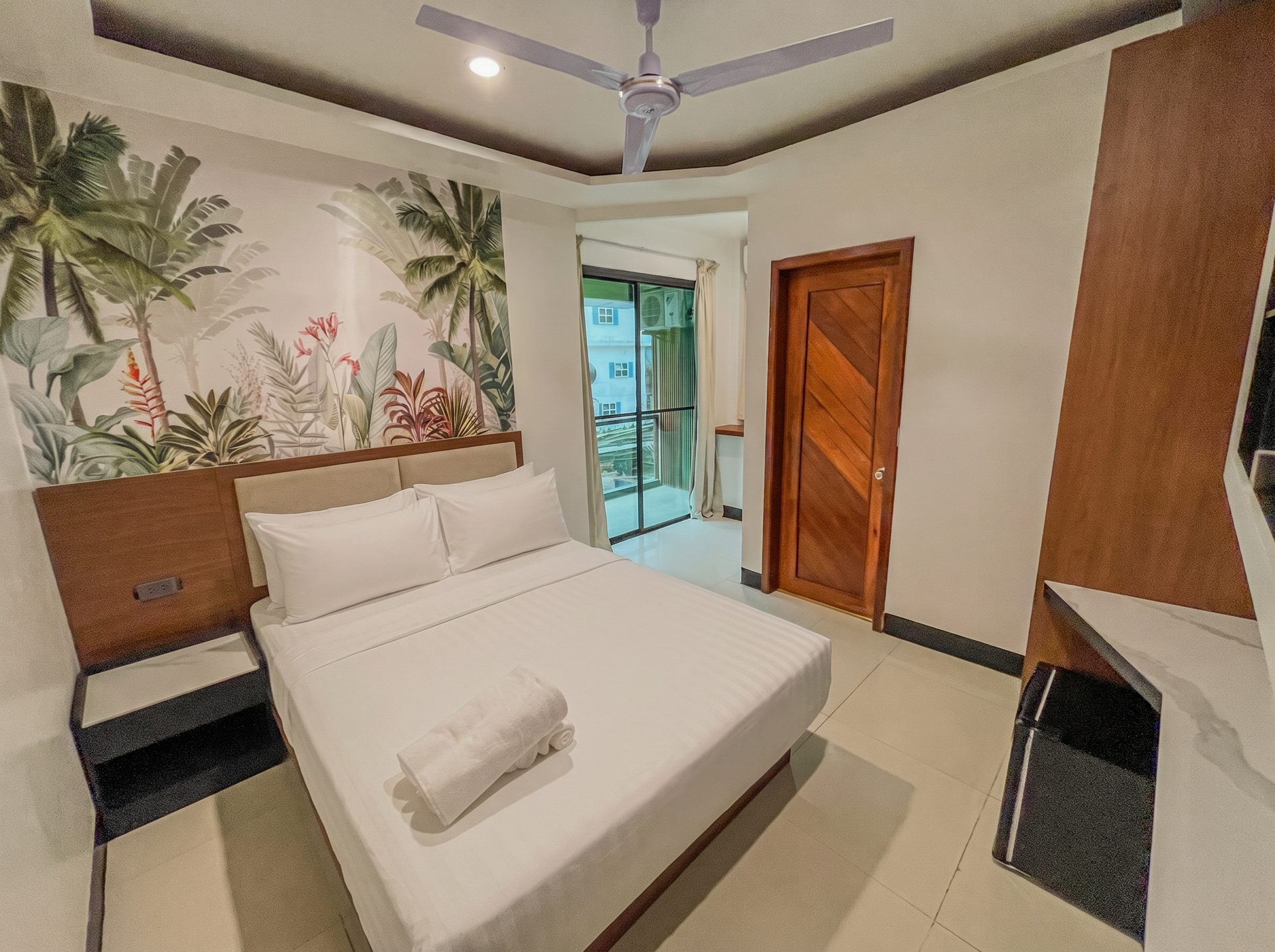 King room with tropical mural and balcony at The Town